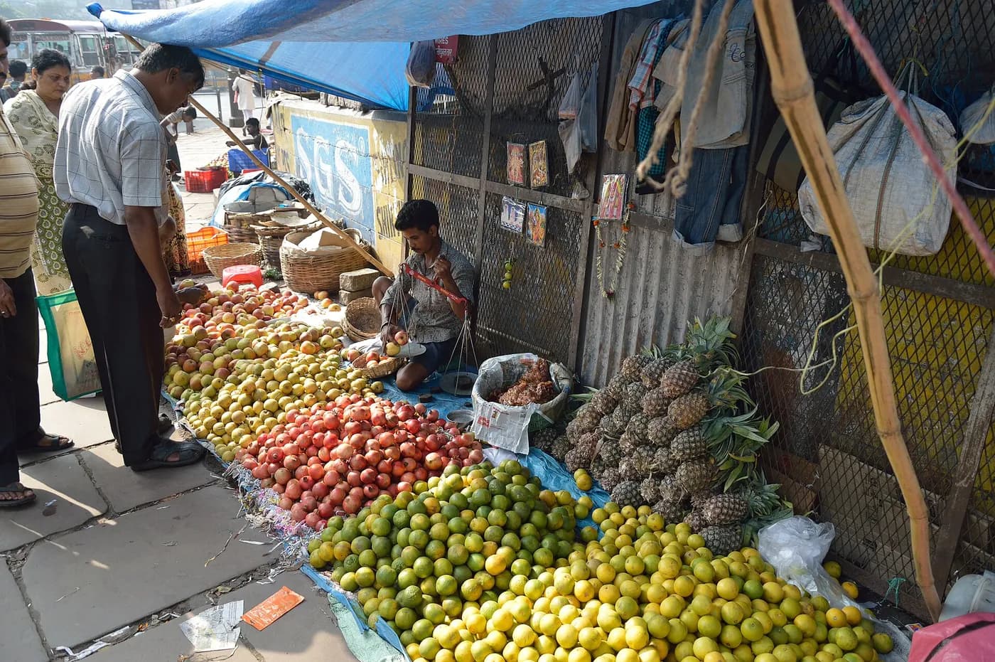 Citrus and pineapple heaped across a market stall